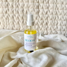 Load image into Gallery viewer, Bottle of 'Bloom' bath and body oil on a textured surface