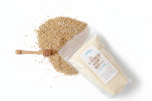 Load image into Gallery viewer, Bag of oatmeal honey salt soak with a honey dipper on a wooden surface