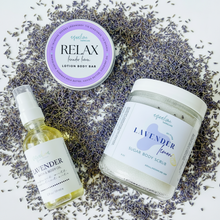 Load image into Gallery viewer, A collection of skincare products including a lotion butter bar, sugar body scrub, and bath &amp; body oil, with labels indicating Eucalyptus and Lavender scents, presented on a soft surface with a 'BREATHE' branded lid in the background.
