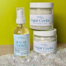 Load image into Gallery viewer, Three skincare products labeled &#39;Sugar Cookie&#39; on a glittery surface with a green background