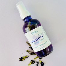 Load image into Gallery viewer, A bottle of Butterfly Bloom Facial Toner with its contents visible, featuring natural ingredients such as aloe vera and butterfly pea flower. The product is labeled as a 'Facial Toning Mist' and is presented with a spray nozzle.